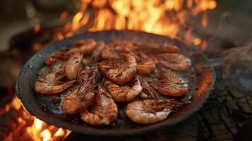 A plate of firegrilled shrimp perfectly charred on the outside and juicy on the inside surrounded by the mesmerizing glow of the open fire photo