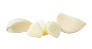 Top view of peeled garlic cloves with slices in stack isolated with clipping path in file format png