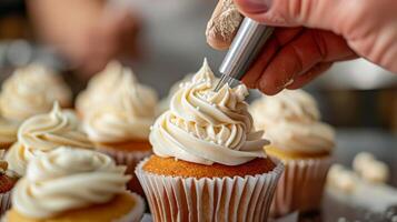 A closeup of a baker skillfully piping icing onto a cupcake as part of an alcoholfree baking and decorating class photo