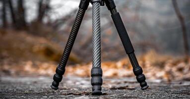 A foldable tripod with a carbon fiber frame and interchangeable lens attachments for versatile use photo