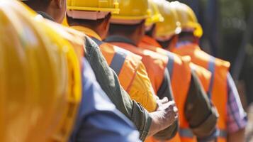 A group of workers patting each others shoulders as they pass by signaling that theyve all passed the safety gear check photo