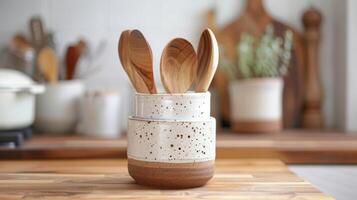 A versatile utensil holder handcrafted with a blend of stoneware and porcelain clay and featuring a minimalist design suitable for any kitchen decor. photo