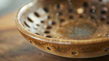 A detailed shot of a ceramic incense holder showcasing the precision used to create multiple holes of varying sizes ideal for burning various types of incense. photo