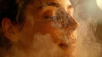 A closeup of a persons relaxed face as they take a deep breath in a sauna surrounded by eucalyptusinfused steam showing the rejuvenating effects of using saunas to manage SAD. photo