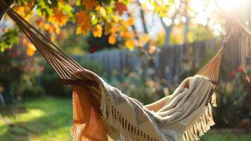 A day spent embracing nature snuggled up in a blanket in a backyard hammock listening to the sound of birds chirping and leaves rustling photo