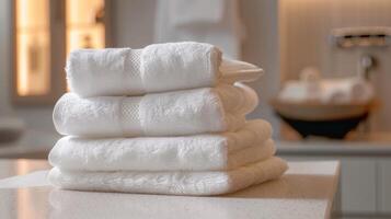 A stack of clean white towels waiting to be used in the sauna and massage rooms ensuring a hygienic and luxurious experience. photo