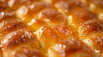 A closeup of a stillwarm brioche bread with its delicate swirls coated in a shiny honey glaze photo