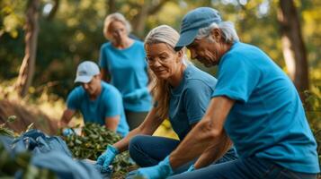 A team of retirees in matching ecofriendly tshirts cleaning up a park and sorting recyclables to reduce waste photo