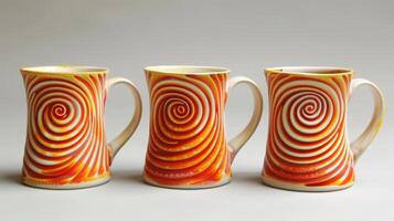 A set of mugs with swirling patterns of bright orange and yellow resembling a fiery sunset and achieved through precise soda firing techniques. photo