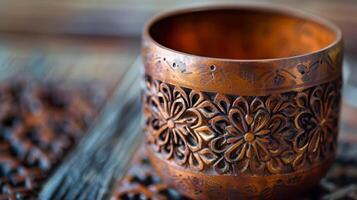 A closeup of a halffinished votive holder with intricate patterns pressed into the surface. photo