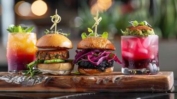 A trio of plantbased sliders each paired with a different mocktail such as a black bean slider with a blueberry and lavender mocktail a falafel slider with a cucumber and mint mocktai photo
