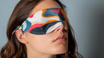 A designer sleep mask featuring a bold abstract print fusing fashion and function for a truly deluxe experience photo