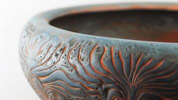 A series of bowls with a unique textured rim achieved through the sgraffito technique where layers of clay are carved away to reveal contrasting colors and patterns. photo