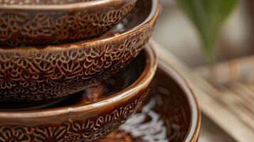 A tiered ceramic fruit bowl with multiple layers of intricate handcarved designs and a glossy finish. photo