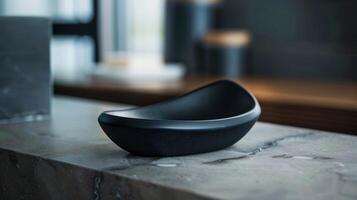 A sleek black soap dish with a unique triangular design and matte finish. photo