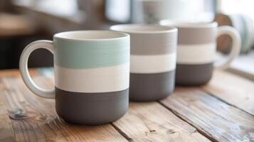 A set of ceramic mugs with a modern minimalistic design featuring clean lines and a muted color palette inspired by Scandinavian interior design. photo