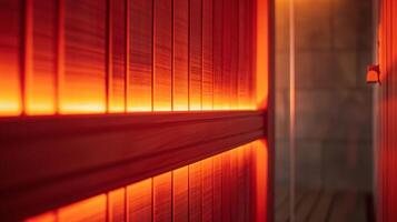 The sauna panel glows with a warm red hue casting a calm and soothing light throughout the room. photo