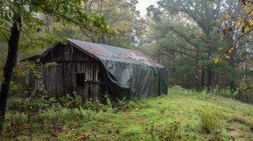 A tarp covering a section of the building protecting it from the heavy rain photo