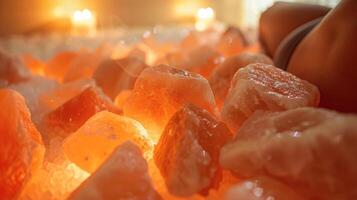 A person using the sauna with Himalayan salt rocks combining both detoxification and mineral absorption for optimal health. photo