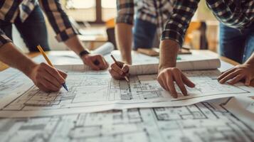 A group of architects collaborating on a home renovation project poring over blueprints and discussing structural changes photo