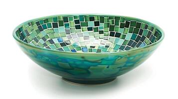A ceramic bowl featuring a handpainted mosaic pattern in vibrant shades of green and blue. photo