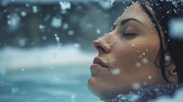 The winter chill seems to melt away as the woman continues to soak in the warmth of the sauna almost forgetting that its winter outside. photo