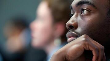 A closeup shot of a mans face as he listens intently and displays active listening skills during a workshop activity photo