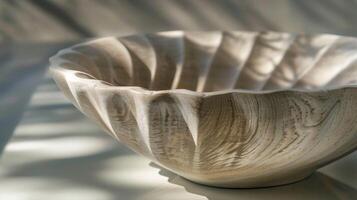 The interplay of light and shadows on a fluted pottery piece creates a sense of depth and dimension. photo