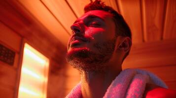 A man with a towel around his neck signaling a postworkout session in an infrared sauna promoting lung expansion and improved oxygen flow. photo