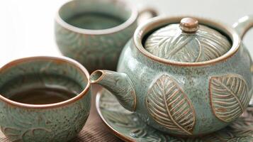 A natureinspired ceramic tea set featuring a beautiful green glaze and handcarved leaf motifs bringing a sense of serenity and tranquility to tea time. photo