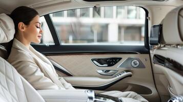 A woman admiring the intricate details and plush interior of a luxury sedan photo