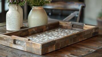 An elegant serving tray crafted from reclaimed wood and lined with mosaic pieces of ceramic creating a stunning mosaic effect. photo