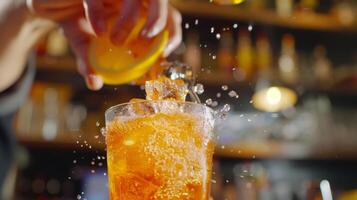 The bartender adds a spritz of fizzy soda to a citrusy mocktail creating a perfect balance of flavors photo