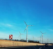 Austria, road to Vienna from Bratislava - 01.14.2024 Wind farm park next to a road in Austria in sunny weather photo