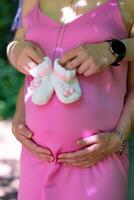 pregnant woman her partner keep hands stomach booties stomach concept pregnancy motherhood preparation expectation photo