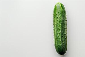 Single ripe cucumber isolated on a white background, perfect for a minimalist design photo