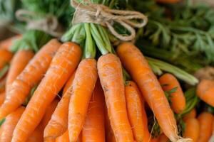 Close up of carrots in a bunch, tied with twine, emphasizing the natural and fresh harvest theme photo