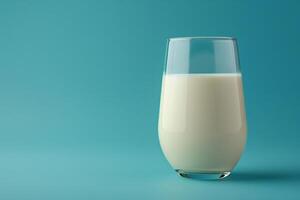 Glass of milk with a soft gradient blue background, creating a calm and refreshing visual photo