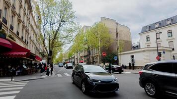 Busy Parisian street scene with outdoor cafe and pedestrians, perfect for travel, lifestyle concepts, and Bastille Day celebrations photo