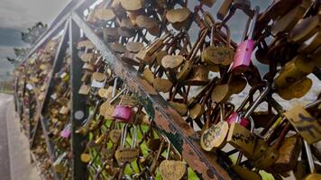 Close up of numerous love locks attached to a bridge railing symbolizing romance and commitment, ideal for Valentines Day and wedding concepts photo