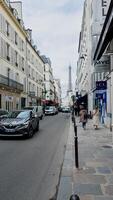 Daily life in Paris with locals strolling on a spring day, showcasing the iconic Eiffel Tower in the backdrop, captured on April 14th, 2024 photo