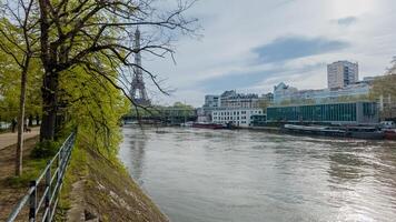 Scenic view of the Seine River with budding spring trees and the iconic Eiffel Tower in the background, shot in Paris, France on April 14th, 2024 photo
