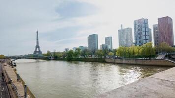 Springtime panorama of the Seine river with the Eiffel Tower and modern Parisian architecture, Paris, France, captured on April 14th, 2024, ideal for travel and culture themes photo