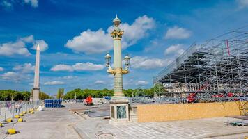 Renovation works at Place de la Concorde with scaffolding around Luxor Obelisk, Paris, France, under a sunny sky on April 14th, 2024, Bastille Day preparations photo