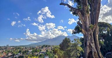 Beautiful landscape morning view of Mount Salak or Gunung Salak taken from batu tulis area in central Bogor city Indonesia photo