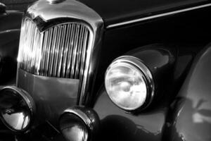 The front grill and headlight of the old beautiful car on the background copy space, card background photo