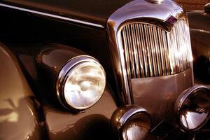 The front grill and headlight of the old beautiful car on the background copy space, card background photo