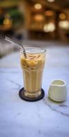 Fresh iced coffee in glass with frothy cream for your design, Food concept in style, copy space photo