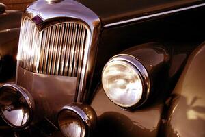 The front grill and headlight of the old beautiful car on the background copy space, card background photo