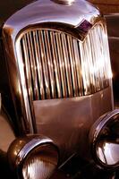 The front grill and headlight of the old beautiful car on the background copy space, card background photo